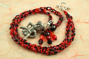 Sheela-na-gig necklace - red and black, circle, md