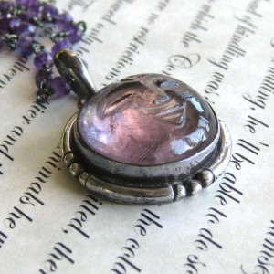 Carved amethyst moon face pendant