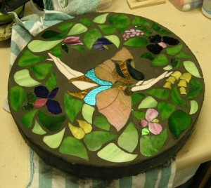 This is a 16 inch stepping stone with a glass diving fairie with glass ivy and flowers-1
