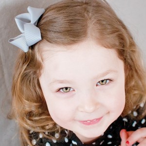 Gray Small Twisted Boutique Hair Bow on a Toddler