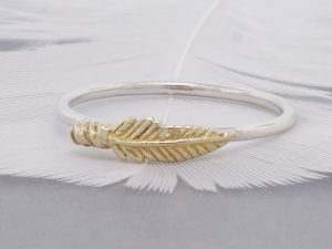 gold-feather-on-a-silver-band-stack-ring