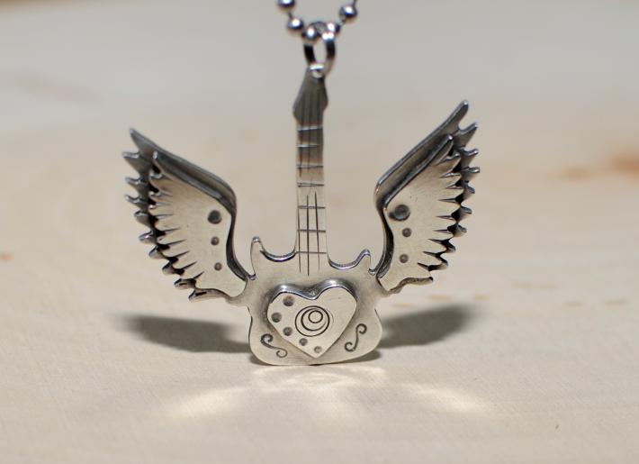 Winged guitar in sterling silver 